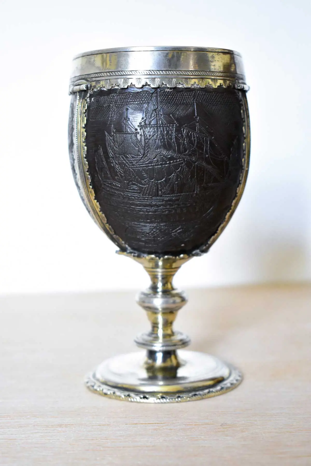 AN EARLY 18TH CENTURY COCONUT CHALICE MOUNTED IN 17TH CENTURY 'PIRATE' SILVER