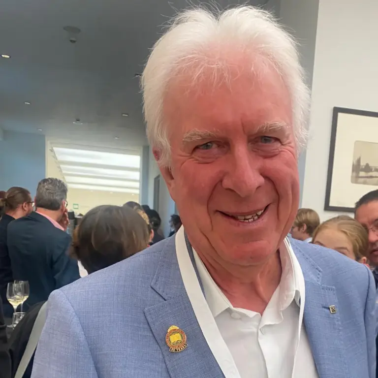 Bruce Marshall wearing his Antiquarian Booksellers Association 50-year badge at a book fair